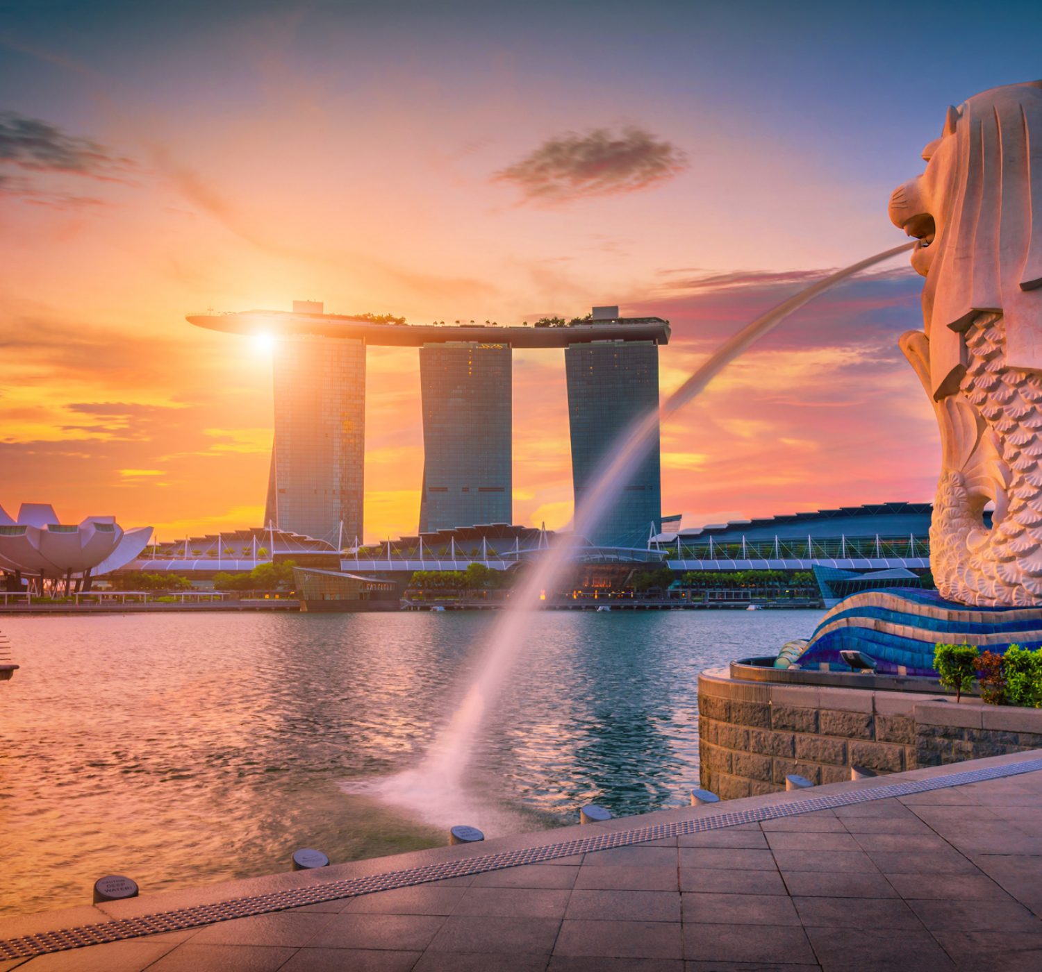 SINGAPORE-JULY 9, 2016: Merlion statue fountain in Merlion Park and Singapore city skyline at sunrise on July 9, 2016. Merlion fountain is one of the most famous tourist attraction in Singapore.